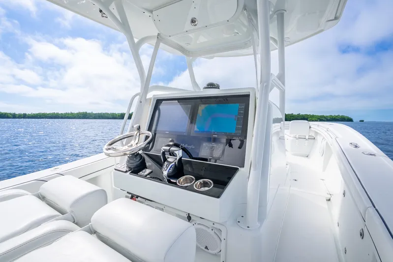  Yacht Photos Pics 2016 Yellowfin 36 Offshore boat cockpit with navigation system, steering wheel, and ocean view.