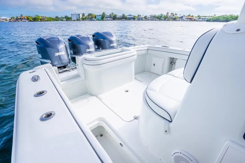  Yacht Photos Pics 2016 Yellowfin 36 Offshore boat with triple 300 horsepower engines on calm water.