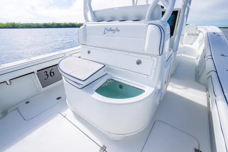  Yacht Photos Pics 2016 Yellowfin 36 Offshore boat interior with seating and storage, on calm water.