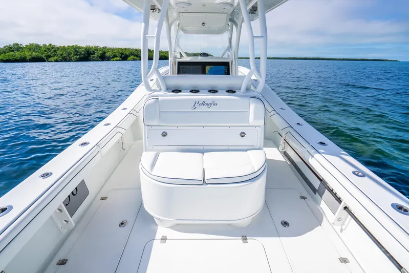  Yacht Photos Pics 2016 Yellowfin 36 Offshore boat interior with seating, on calm blue water.