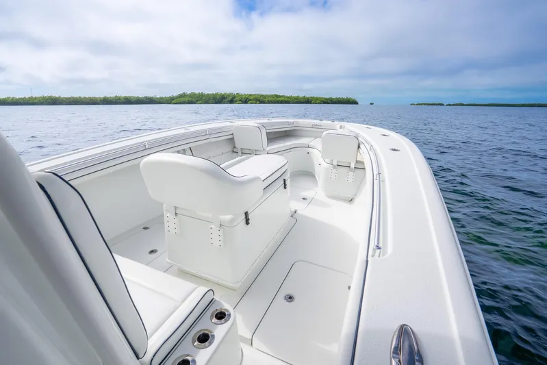  Yacht Photos Pics 2016 Yellowfin 36 Offshore boat on calm waters, featuring sleek white seating and open deck.