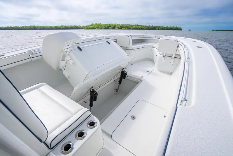  Yacht Photos Pics 2016 Yellowfin 36 Offshore boat interior with seating and storage, on calm waters.