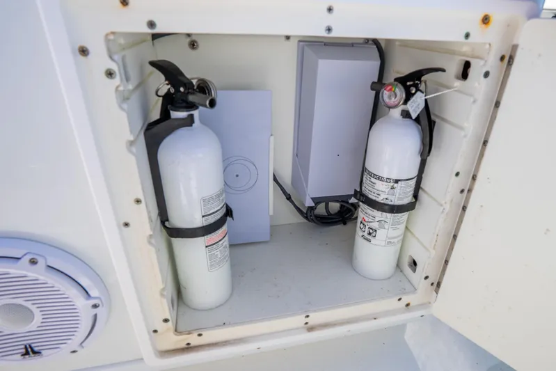  Yacht Photos Pics Storage compartment with fire extinguishers on a 2016 Yellowfin 36 Offshore boat.