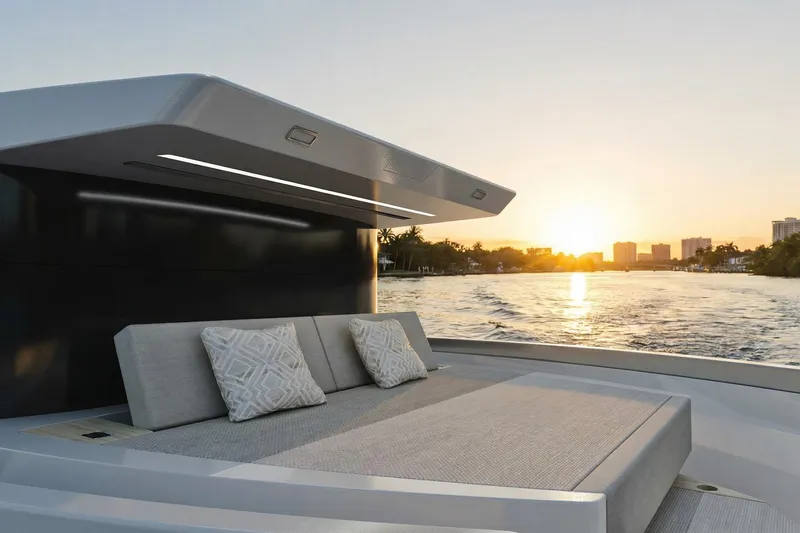  Yacht Photos Pics 2026 Ladenstein L48 MIAMI yacht deck at sunset, featuring luxurious seating and scenic water views.