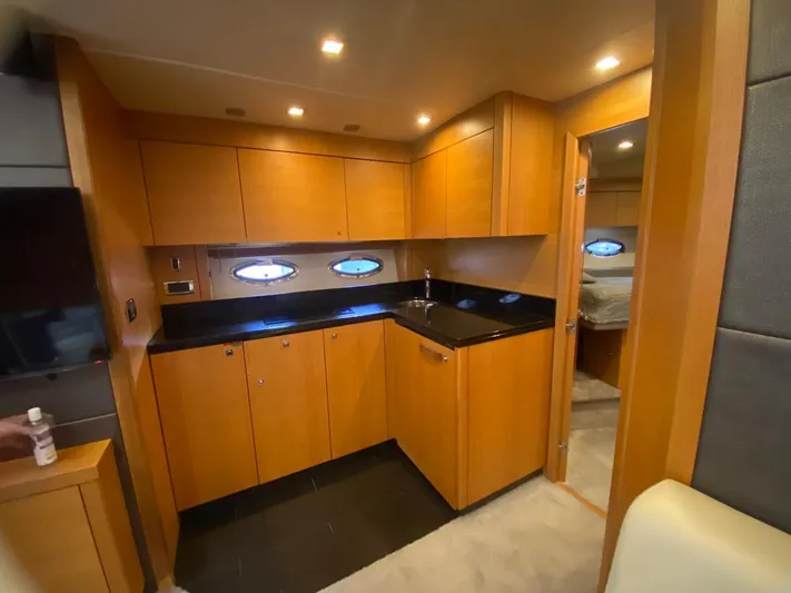  Yacht Photos Pics Luxurious 2014 Sunseeker 48 Portofino XPS yacht interior kitchen with wood cabinetry.