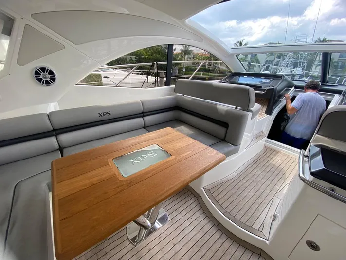  Yacht Photos Pics Luxurious 2014 Sunseeker 48 Portofino XPS yacht interior with elegant seating and wooden table.