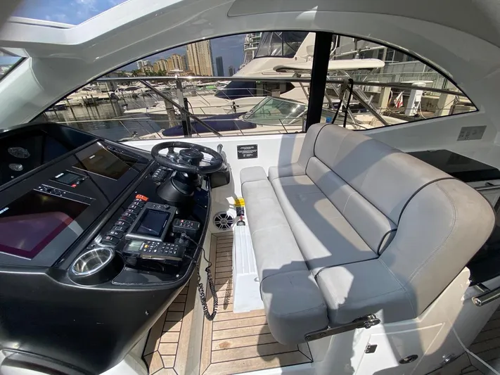  Yacht Photos Pics Interior of 2014 Sunseeker 48 Portofino XPS yacht cockpit with steering and seating area.