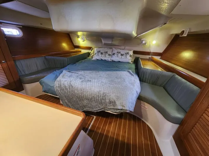 Soleyah Yacht Photos Pics Cozy cabin interior of 2007 Catalina 387 sailboat with comfortable bedding and seating.