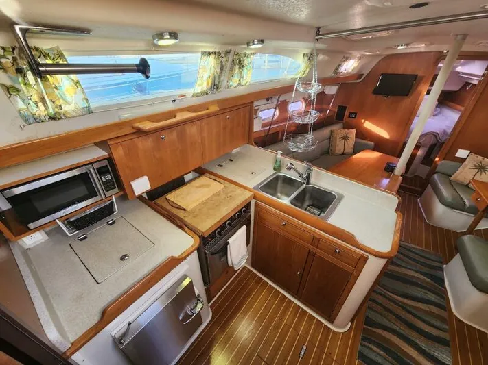 Soleyah Yacht Photos Pics Interior of 2007 Catalina 387 sailboat with modern kitchen and cozy seating area.