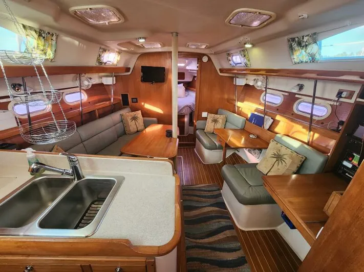 Soleyah Yacht Photos Pics Spacious interior of 2007 Catalina 387 sailboat with cozy seating and modern amenities.