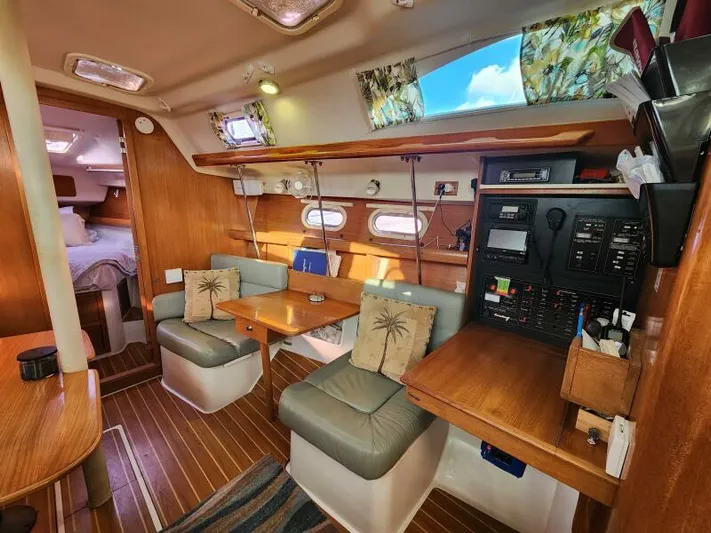 Soleyah Yacht Photos Pics Interior of a 2007 Catalina 387 sailboat with cozy seating and wooden finishes.