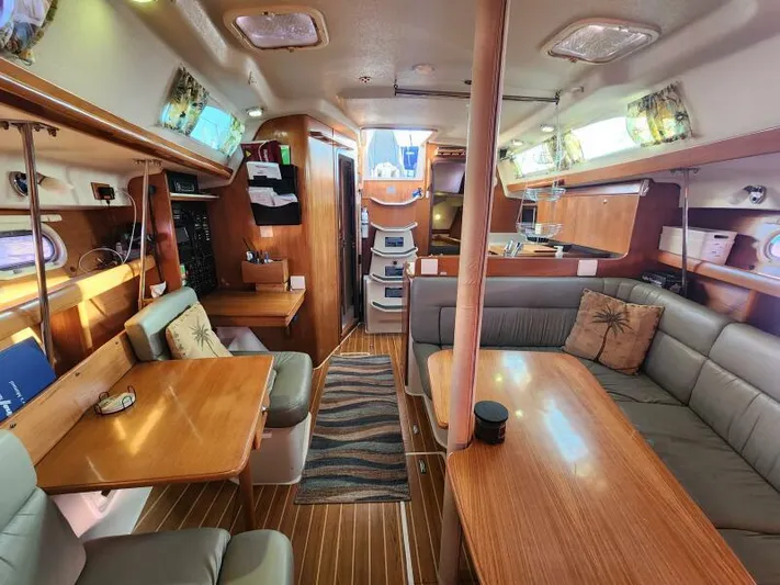 Soleyah Yacht Photos Pics Interior of 2007 Catalina 387 sailboat with cozy seating and wooden finishes.