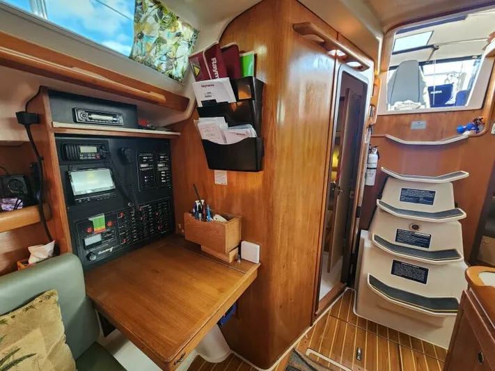 Soleyah Yacht Photos Pics Interior of 2007 Catalina 387 sailboat with navigation station and wooden cabinetry.