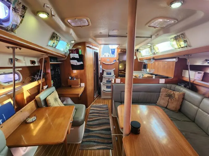 Soleyah Yacht Photos Pics Interior of 2007 Catalina 387 sailboat with cozy seating and wooden finishes.