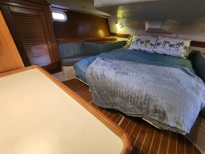 Soleyah Yacht Photos Pics Cozy cabin interior of 2007 Catalina 387 sailboat with bed and wooden furnishings.