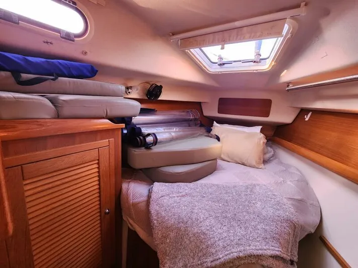Soleyah Yacht Photos Pics Cozy cabin interior of 2007 Catalina 387 sailboat with bedding and storage.