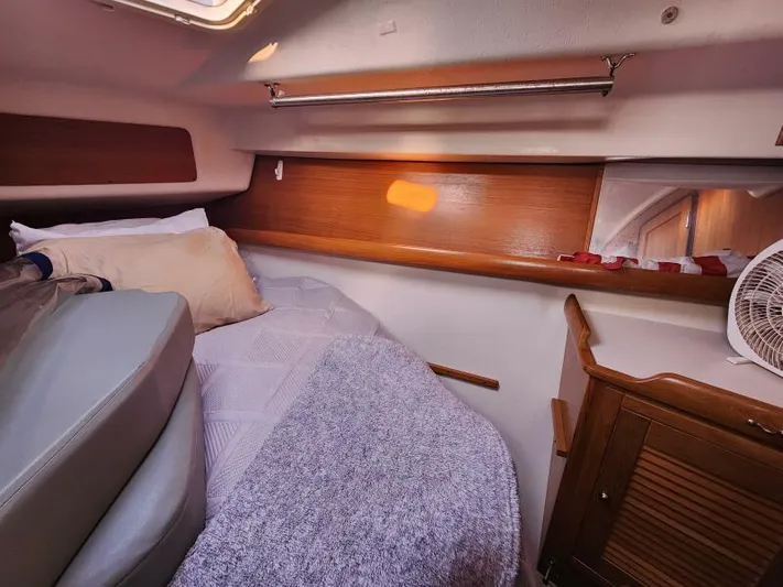 Soleyah Yacht Photos Pics Cozy cabin interior of 2007 Catalina 387 sailboat with bed and wooden cabinetry.