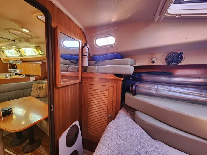 Soleyah Yacht Photos Pics Interior of 2007 Catalina 387 sailboat with cozy seating and wooden cabinetry.