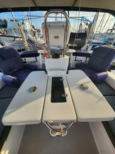 Soleyah Yacht Photos Pics 2007 Catalina 387 yacht cockpit with cushioned seating and table, docked at marina.