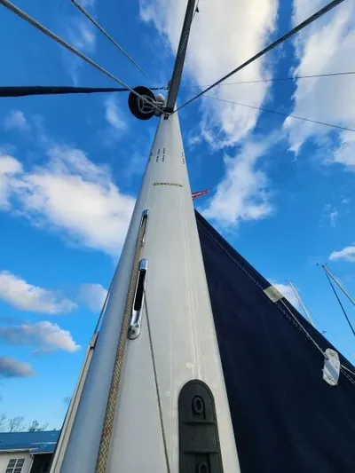 Soleyah Yacht Photos Pics 2007 Catalina 387 sailboat mast against a blue sky with clouds.