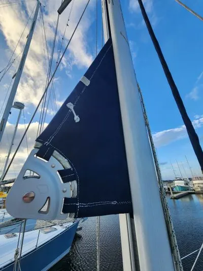 Soleyah Yacht Photos Pics Sailboat mast and sail detail on a 2007 Catalina 387 under a blue sky.
