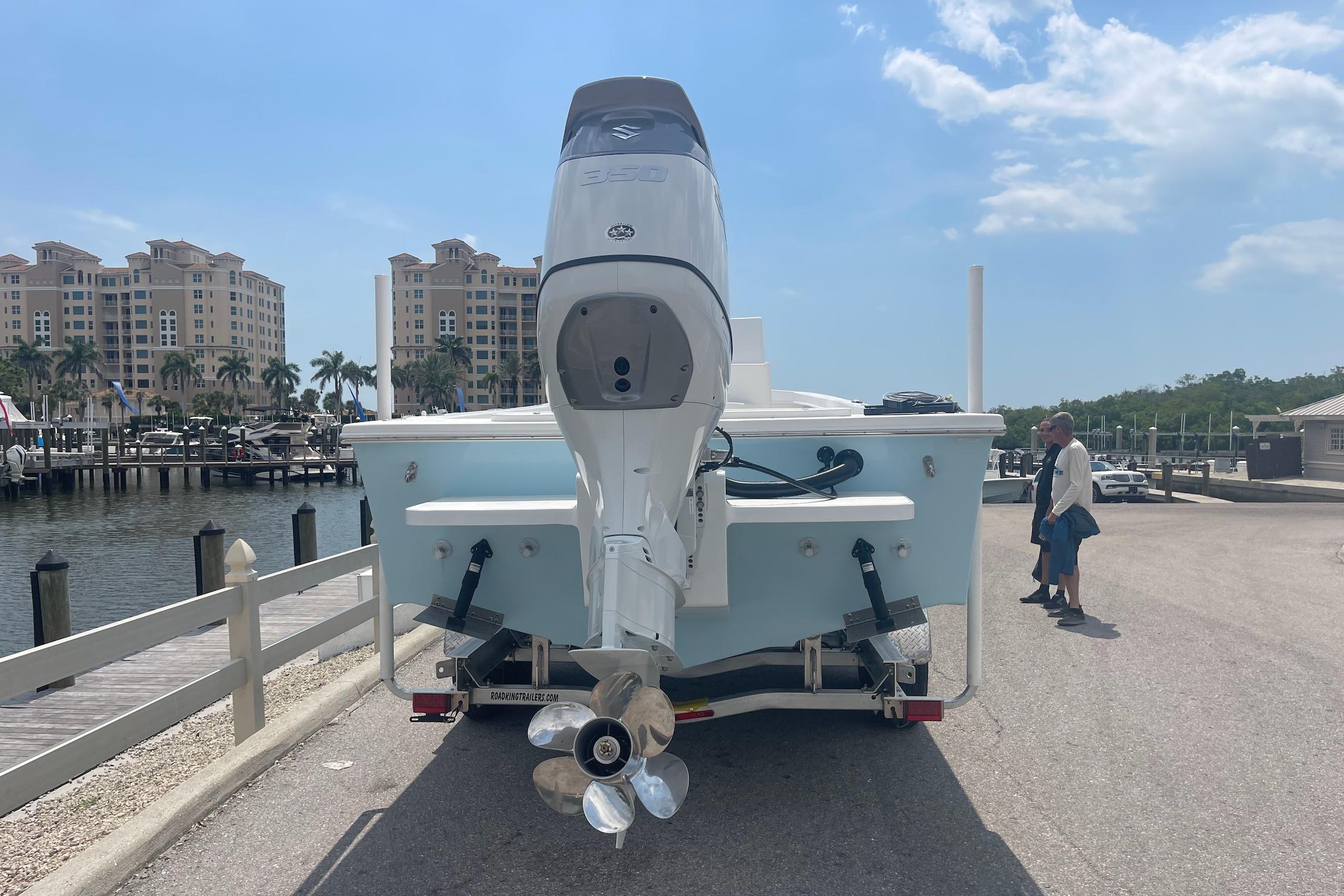 2026 C-Hawk 26 Center Console boat with outboard motor at marina dock.