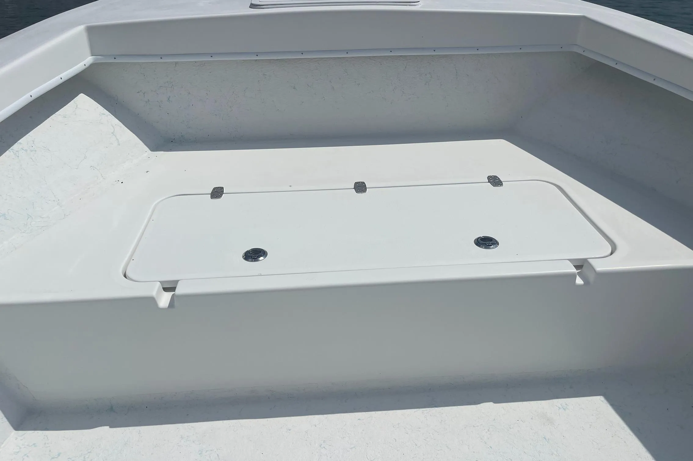 2026 C-Hawk 26 Center Console boat deck with storage compartment.