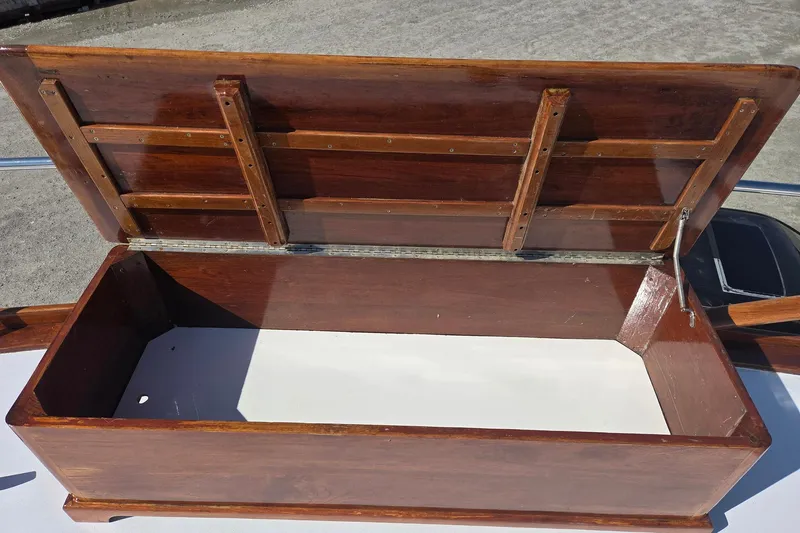 Windrush Yacht Photos Pics Open wooden storage compartment on a 1966 Trumpy 55 boat deck.