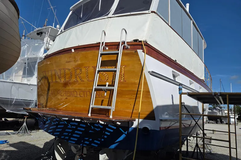 Windrush Yacht Photos Pics 1966 Trumpy 55 yacht "Windrush" in dry dock, showcasing wooden stern and ladder.
