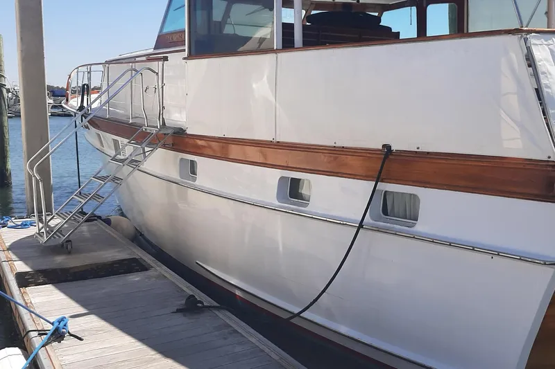 Windrush Yacht Photos Pics 1966 Trumpy 55 yacht docked, featuring classic wooden accents and sleek design.