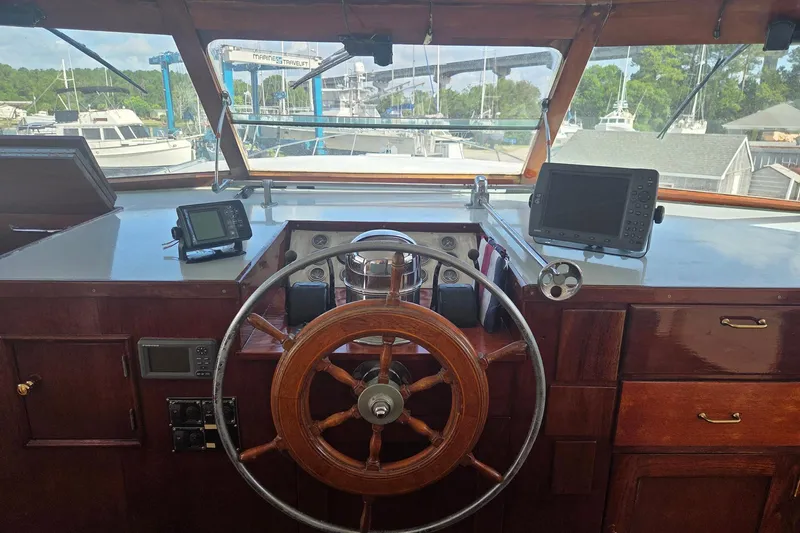 Windrush Yacht Photos Pics Helm of a 1966 Trumpy 55 yacht with wooden wheel and navigation equipment.