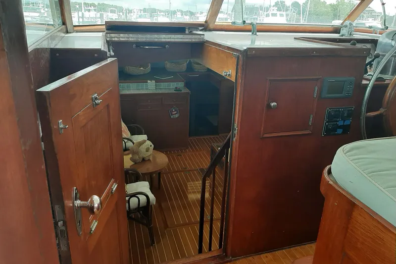 Windrush Yacht Photos Pics Interior of a 1966 Trumpy 55 boat with wooden furnishings and nautical decor.