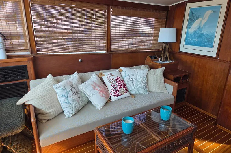 Windrush Yacht Photos Pics Interior of a 1966 Trumpy 55 yacht with cozy seating and nautical decor.