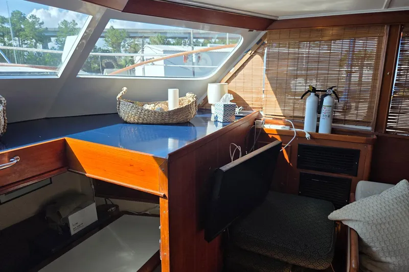 Windrush Yacht Photos Pics Interior of a 1966 Trumpy 55 yacht with wooden accents and wicker baskets.