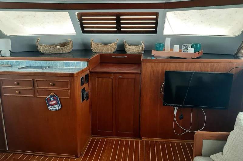 Windrush Yacht Photos Pics Interior of a 1966 Trumpy 55 yacht with wooden cabinetry and modern decor.