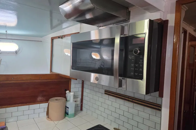 Windrush Yacht Photos Pics Modern kitchen with stainless steel microwave in a 1966 Trumpy 55 yacht.