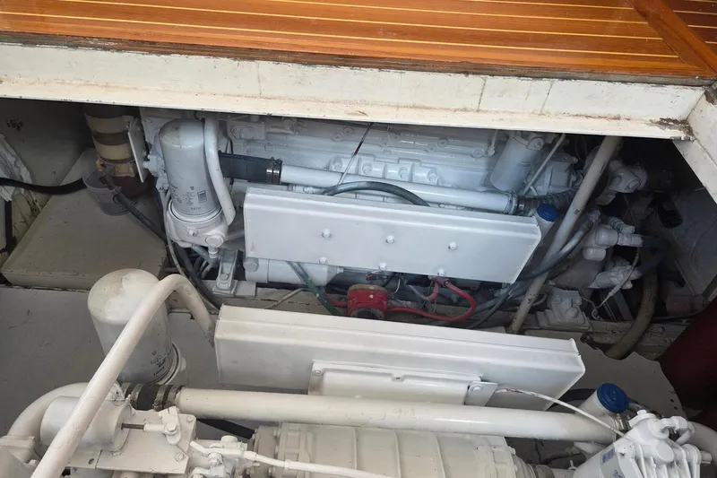 Windrush Yacht Photos Pics Engine compartment of a 1966 Trumpy 55 yacht, showcasing mechanical components and piping.