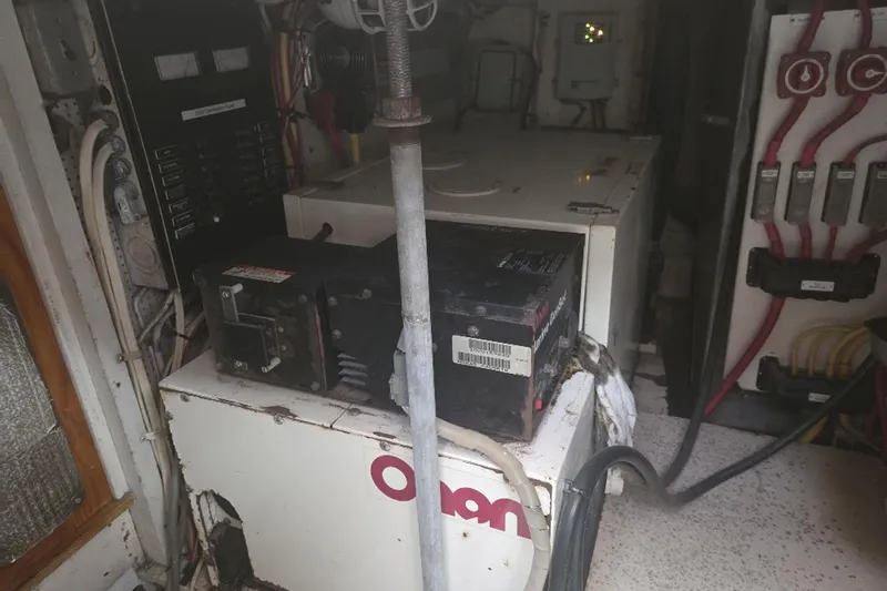 Windrush Yacht Photos Pics Electrical equipment inside a 1966 Trumpy 55 boat, featuring Onan generator and wiring.