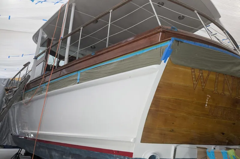 Windrush Yacht Photos Pics Restoration of a 1966 Trumpy 55 yacht with wooden and white painted hull.