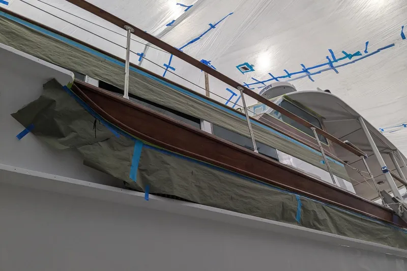 Windrush Yacht Photos Pics 1966 Trumpy 55 yacht under restoration, covered with protective sheets and tape.