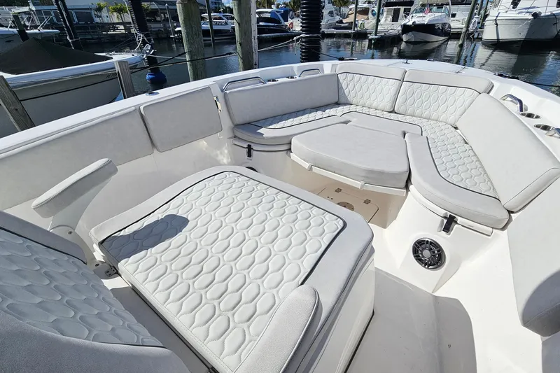  Yacht Photos Pics 2024 Sea Fox 268 Commander boat interior with cushioned seating in a marina setting.