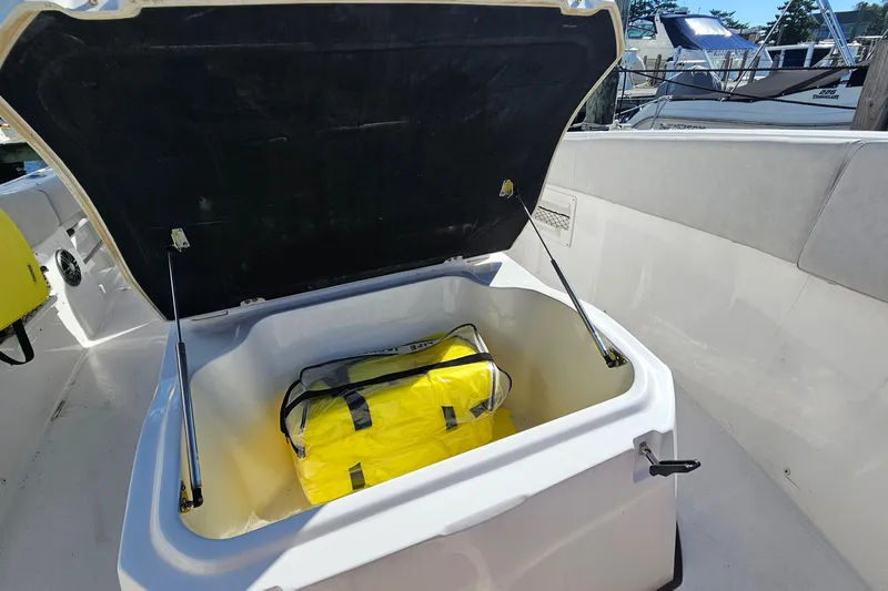  Yacht Photos Pics Open storage compartment on 2024 Sea Fox 268 Commander boat with yellow bag inside.