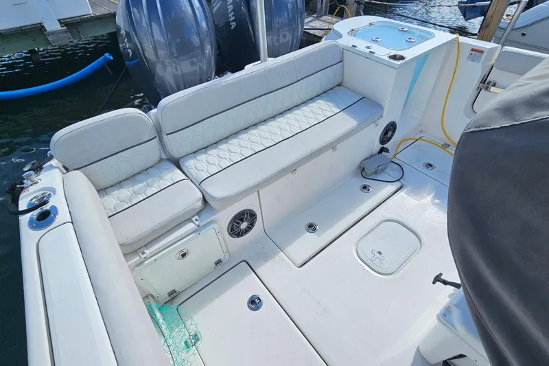  Yacht Photos Pics 2024 Sea Fox 268 Commander boat interior with cushioned seating and dual outboard motors.