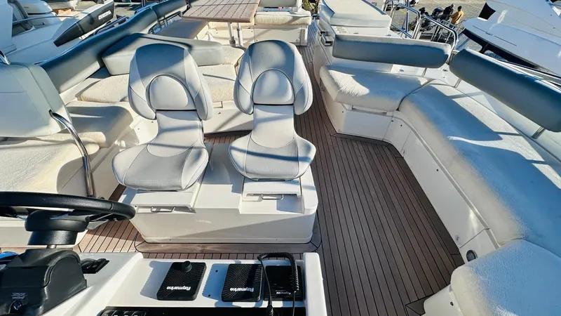  Yacht Photos Pics Luxury seating on 2004 Fairline Squadron 74 yacht deck, featuring modern helm controls.
