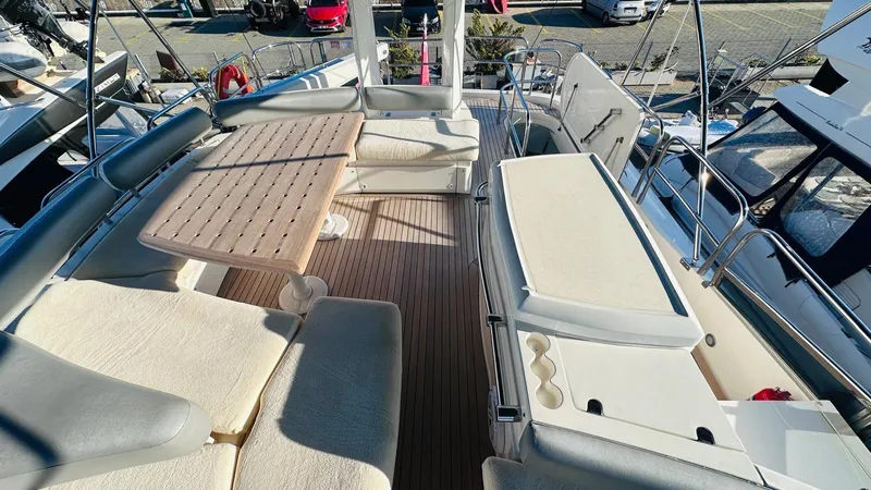  Yacht Photos Pics Luxurious 2004 Fairline Squadron 74 yacht deck with seating and table.