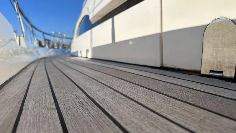  Yacht Photos Pics Teak deck of 2004 Fairline Squadron 74 yacht under clear blue sky.