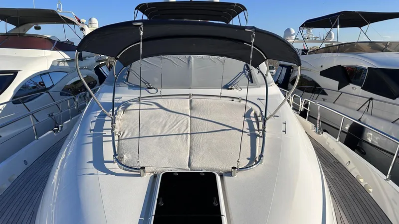  Yacht Photos Pics 2004 Fairline Squadron 74 yacht with sunshade and sleek design, docked alongside other boats.