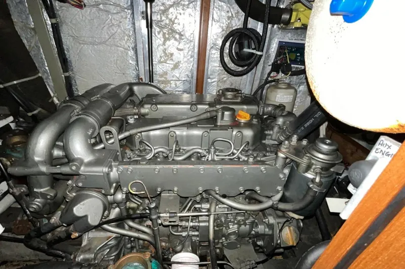  Yacht Photos Pics Engine compartment of a 2004 Hylas 49 sailboat, showcasing detailed mechanical components.