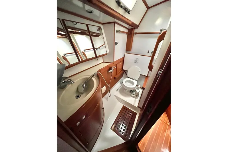  Yacht Photos Pics Luxurious 2004 Hylas 49 yacht bathroom with wood accents and modern fixtures.