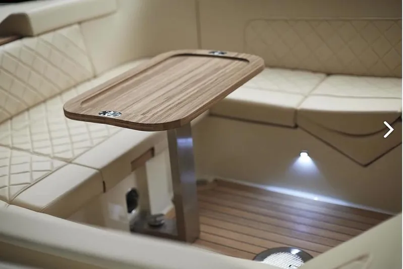  Yacht Photos Pics Luxurious interior of 2019 Chris-Craft Corsair 30 with elegant seating and wooden table.